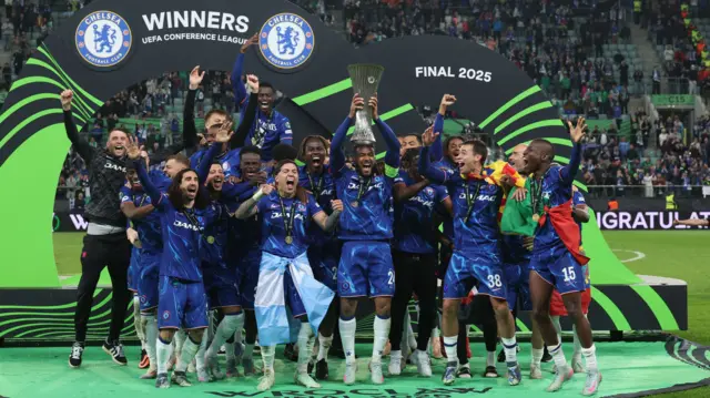 Reece James lifts the Conference League trophy while his Chelsea team-mates celebrate