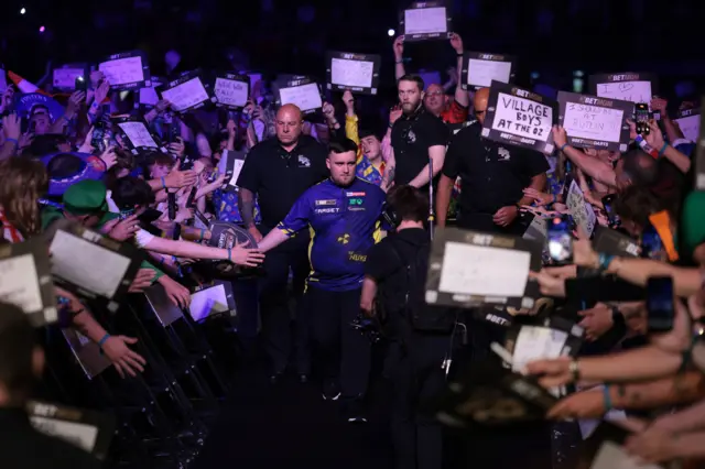 Luke Littler prepares to walk on for the Premier League Darts final