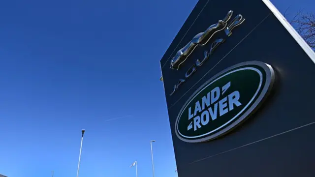 A sign that reads Jaguar and Land Rover with the company logos