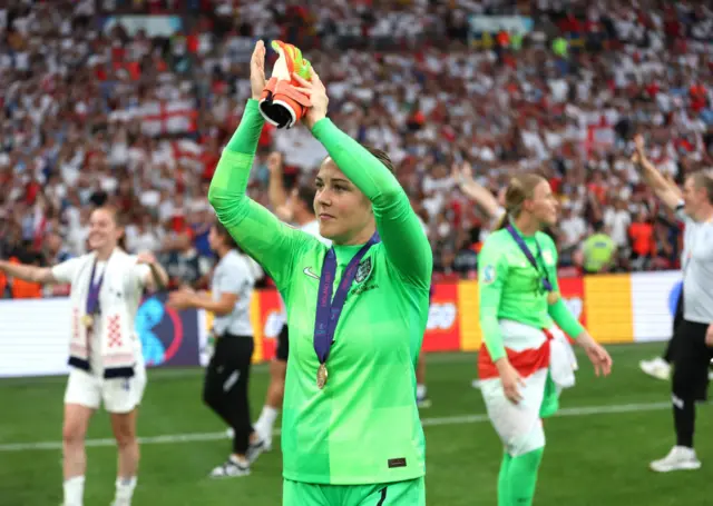 Mary Earps clapping with the Euros winners medal around her neck