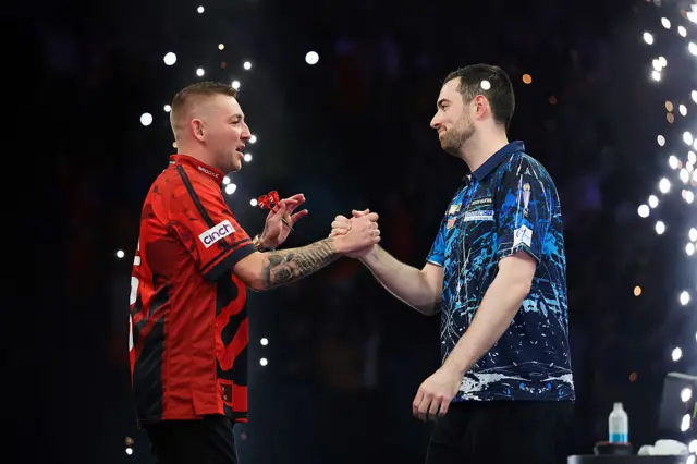 Luke Humphries and Nathan Aspinall  embrace after their last meeting on the Premier League Darts circuit