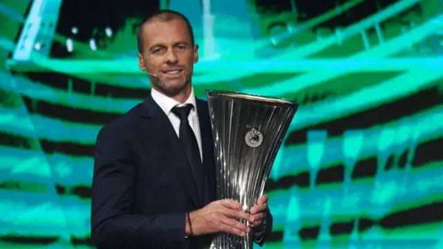 Aleksander Ceferin holds the Uefa Conference League trophy