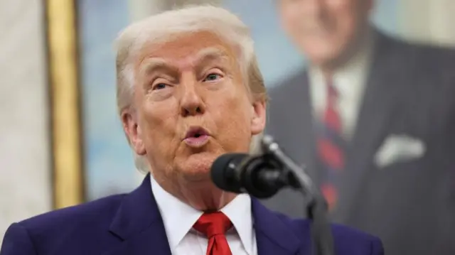 Donald Trump speaking into a microphone