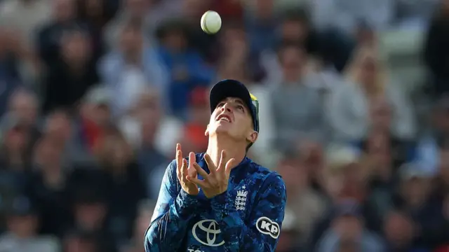 England's Harry Brook catches the ball to take the wicket of West Indies' Gudakesh Motie