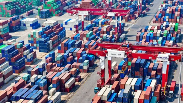 rail-mounted crane transports goods at the cargo yard of the Qianwan United Container Terminal
