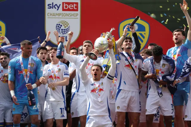 Leeds captain Ethan Ampadu holds up the Championship trophy