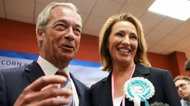Nigel Farage and Sarah Pochin pose to the camera