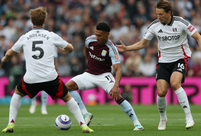 Aston Villa's Ollie Watkins in action with Fulham's Joachim Andersen and Sander Berge