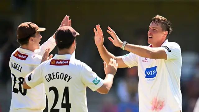 Migael Pretorius (right) takes a wicket on day one at Taunton