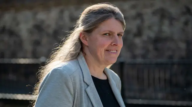 Rachael Maskell walking in grey blazer.