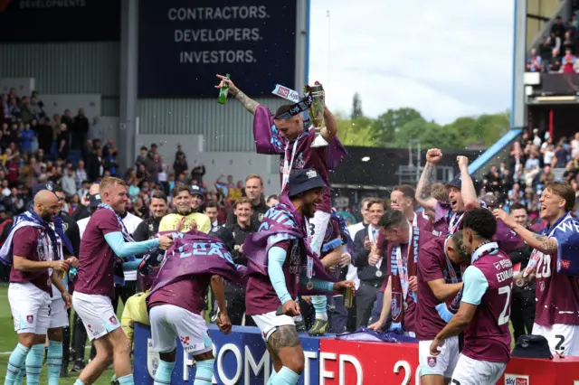 Burnley players celebrate winning promotion to the Premier League