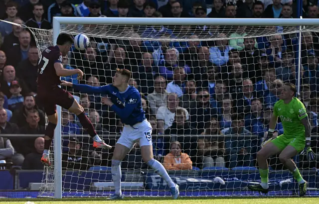 George Hirst (C) scores