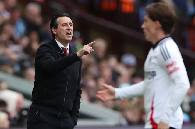 Unai Emery (L) gestures on the touchline