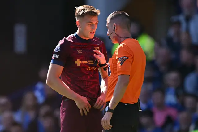 Referee Lewis Smith talks to Ipswich Town's English Liam Delap