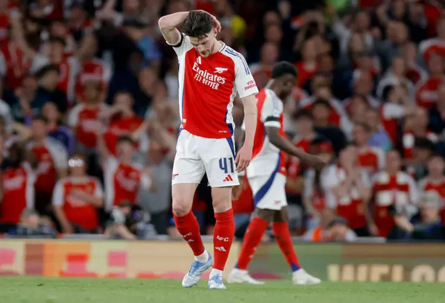 Declan Rice with his hand on his head against PSG