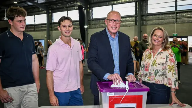 Opposition Leader Peter Dutton casts his vote with his wife Kirilly and sons Harry and Tom.
