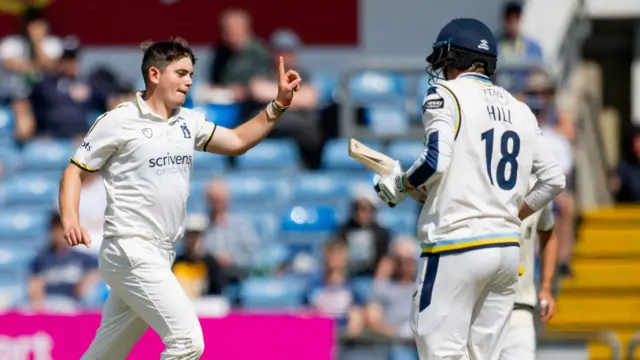 Warwickshire's Ethan Bamber celebrates taking the wicket of Yorkshire's George Hill