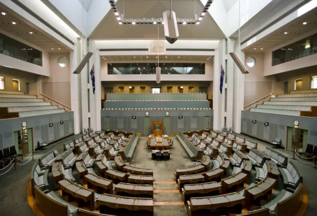 A photo of an empty House of Representatives at the Australian parliament
