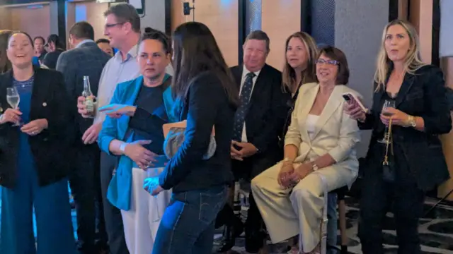 A group of people chat among each other