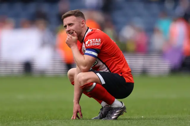 Luton's Jordan Clark looks dejected after relegation
