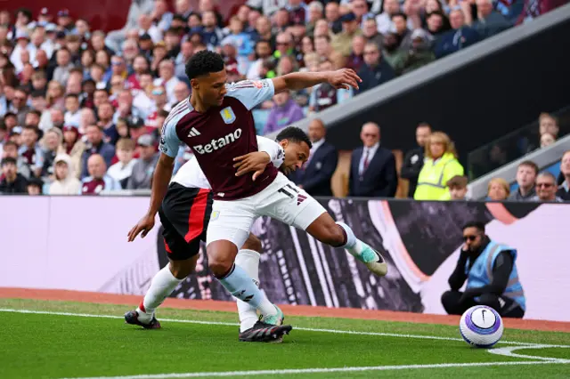 Ollie Watkins of Aston Villa is challenged by Kenny Tete