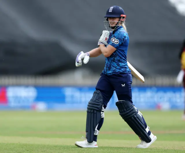 England's Emma Lamb walks after losing her wicket, caught by West Indies' Mandy Mangru