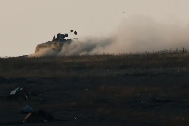 An Israeli APC manoeuvres in Gaza, near the Israel-Gaza border, as seen from Israel, May 29, 2025.