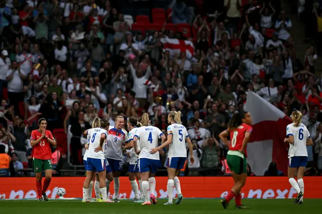 Beever-Jones is mobbed by her teammates after scoring her hat-trick goal