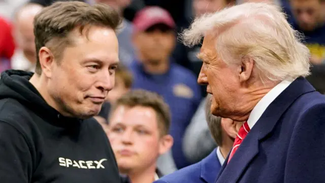 Elon Musk greets U.S. President Donald Trump as they attend the NCAA men's wrestling championships in Philadelphia, Pennsylvania, U.S., March 22, 2025