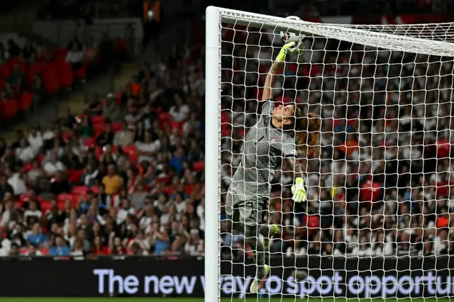 Pereira tips the ball onto the bar