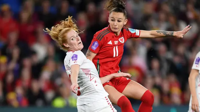 Hannah Cain (right) of Wales heads at goal against Denmark in April