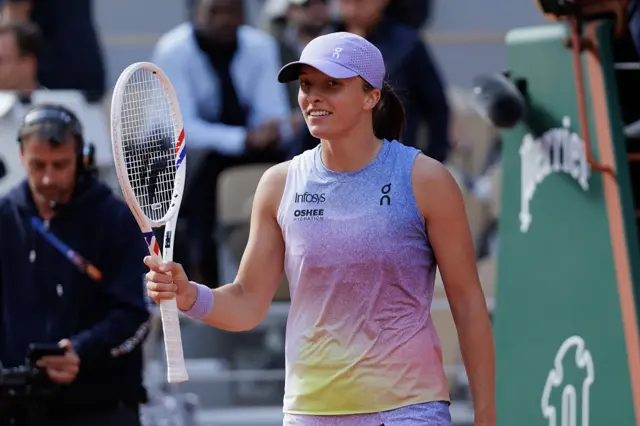 Iga Swiatek celebrates beating Emma Raducanu at the French Open