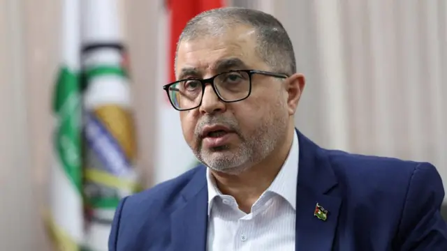 A file photo of Hamas official Basem Naim, he is wearing a suit and speaking to someone off camera