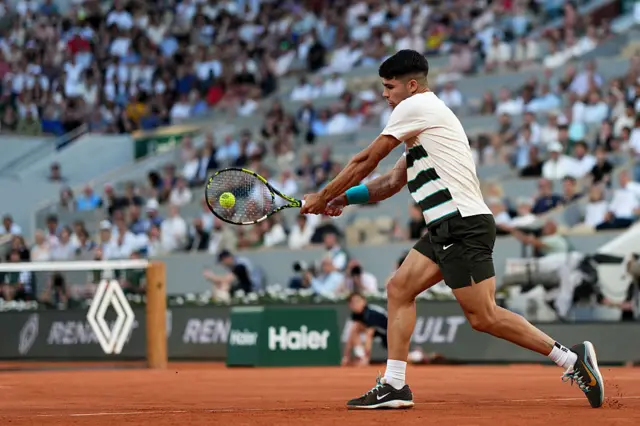 Carlos Alcaraz hits a backhand