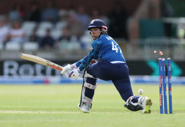 Sophia Dunkley sweeps into her stumps