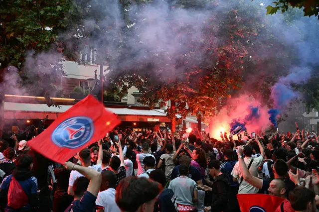 Paris Saint-Germain supporters react after their team's first goal