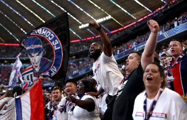 A fan of Paris Saint-Germain reacts as he enjoys the pre match atmosphere