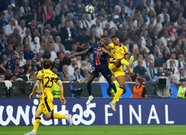 Paris St Germain's Nuno Mendes in action with Inter Milan's Denzel Dumfries