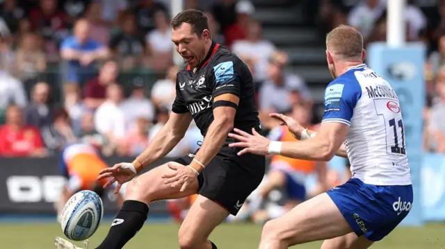 Alex Goode (left) kicks the ball