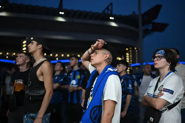 Inter fans watch outside the San Siro stadium