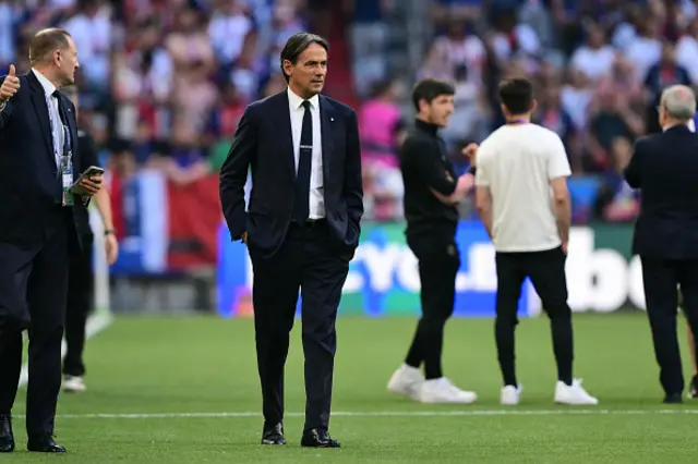 Simone Inzaghi (C) walks on the pitch