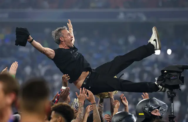 Luis Enrique, Head Coach of Paris Saint-Germain, is thrown into the air