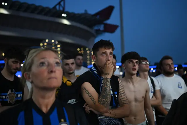 Inter fans watch outside the San Siro stadium
