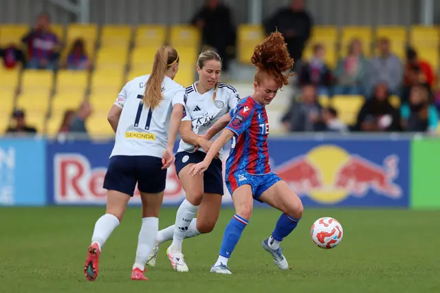 Annabel Blanchard of Crystal Palace controls the ball whilst under pressure from Janice Cayman and Courtney Nevin