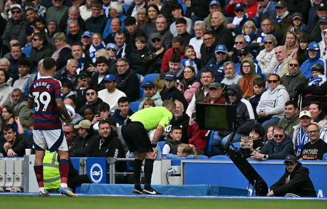 Craig Pawson viewing the VAR monitor