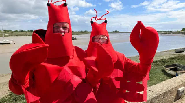 Two people dressed as lobsters