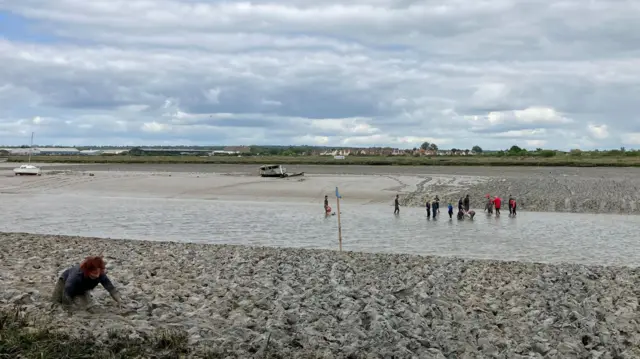 A few people stuck in mud