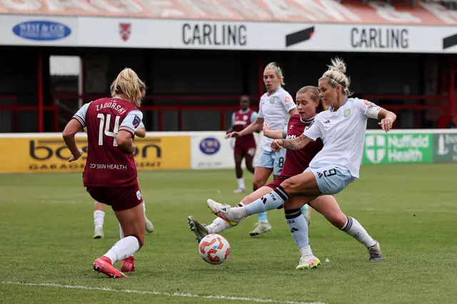 Rachel Daly of Aston Villa shoots whilst under pressure from Shelina Zadorsky of West Ham United during the Barclays Women's Super League match between West Ham United and Aston Villa at Chigwell Construction Stadium