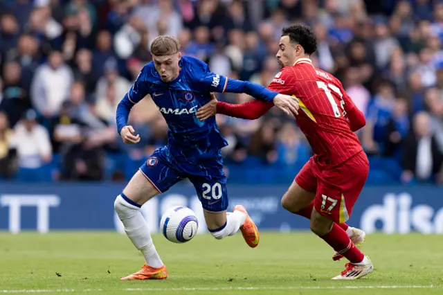 Cole Palmer of Chelsea is challenged by Curtis Jones