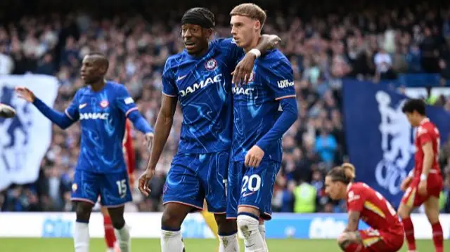 Noni Madueke and Cole Palmer of Chelsea celebrate after Jarell Quansah of Liverpool (not pictured) scores an own goal